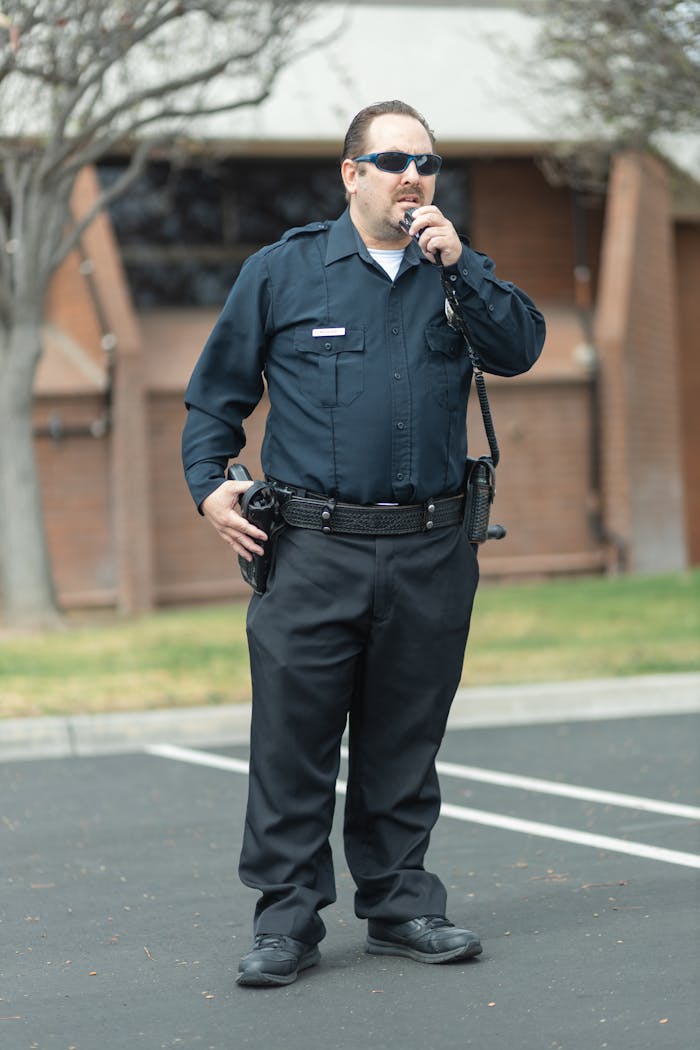 Mastering the First Impression: Your intriguing post title goes here A police officer in uniform communicates via radio, exuding public safety authority.